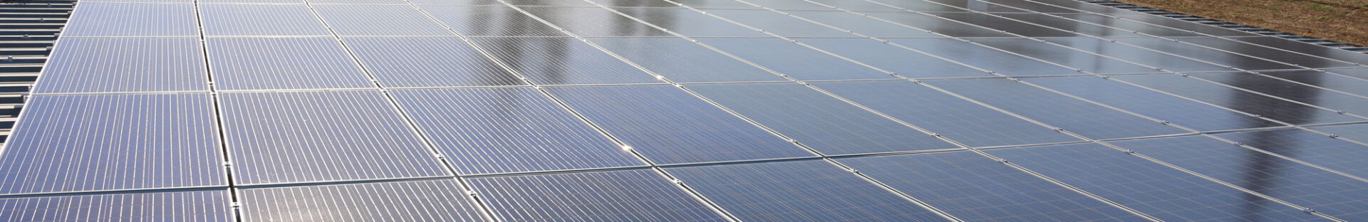 Close-up view of a solar panel array installed on a rooftop under clear skies, addressing common Solar Energy Questions.